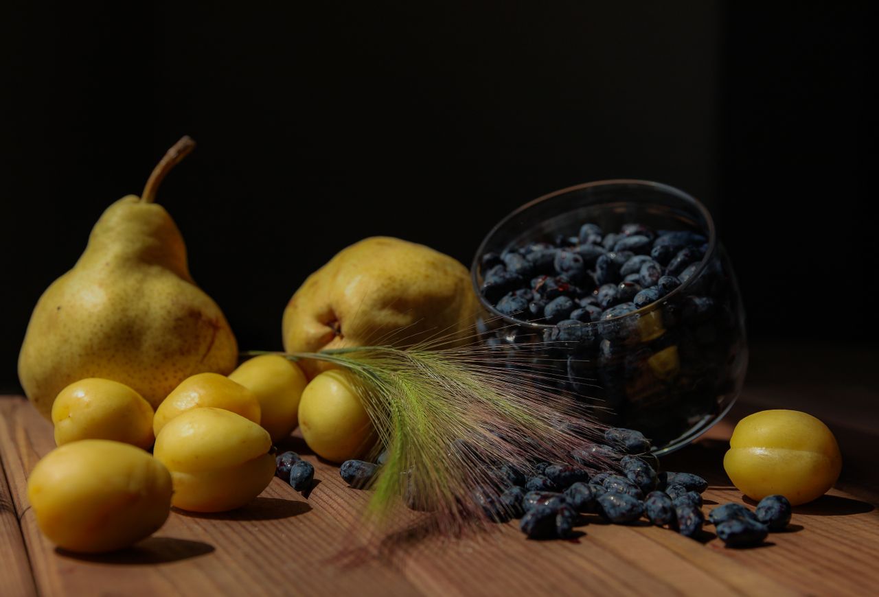 Mastering the First Impression: Your intriguing post title goes here Vivid still life showcasing pears, yellow plums, and blueberries on a wooden surface.