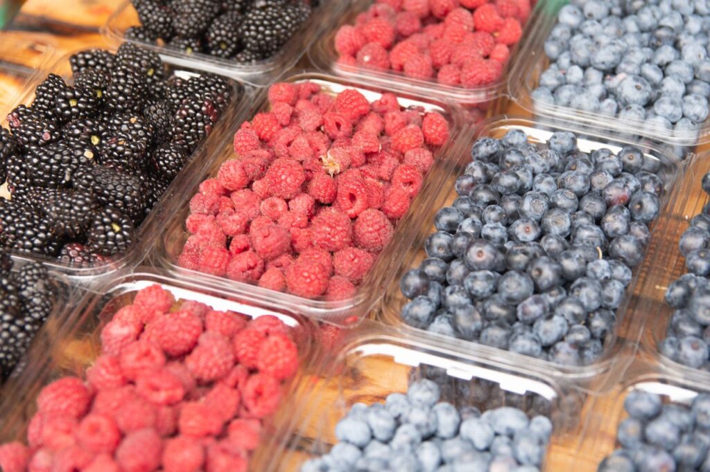 Crafting Captivating Headlines: Your awesome post title goes here Close-up of assorted fresh blackberries, raspberries, and blueberries in clear containers.